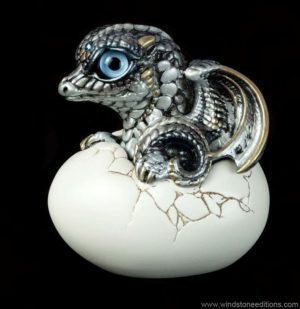 Hatching Dragon (version 2) in Silver with shades of pearly-silver to nearly black, with gold details, light blue eyes, and aquamarine crystal. Hand-painted collectible by Windstone Editions.