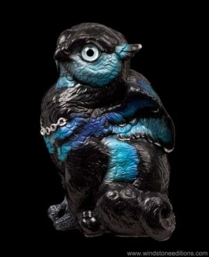 Sitting Griffin Chick fantasy figurine in Blue Morpho with black and metallic blue shades, teal glass eyes, and a clear crystal jewel. Hand-painted collectible by Windstone Editions.