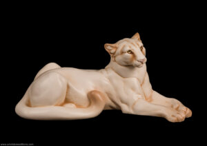 Cougar figurine. Hand-painted in ivory color with gold colored eyes. Collectable sculpture by Windstone Editions