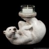 Polar Bear figurine holding a candle with its feet, cast in natural mineral stone, hand-painted, and includes candle and glass votive. Hand-painted collectible by Windstone Editions.