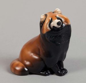 Tanuki painted like a Red Panda with reddish-brown fur, black and white facial markings, black belly, and striped tail. Hand-painted collectible by Windstone Editions