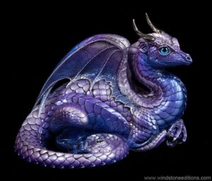 Lap Dragon fantasy figurine in Tanzanite with silver detailing, metallic blue eyes, Tanzanite-colored jewel, and silver pewter horns. Hand-painted collectible by Windstone Editions.