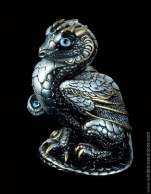 Mini Keeper Dragon fantasy figurine in Silver with gold detailing, light blue glass eyes, and aquamarine-colored crystals. Hand-painted collectible sculpture by Windstone Editions