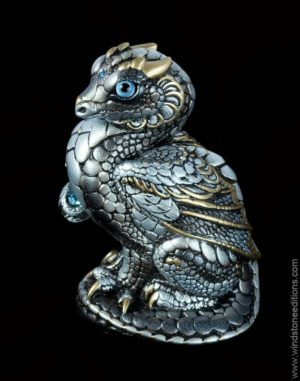 Mini Keeper Dragon fantasy figurine in Silver with silvery shades with gold detailing, light blue glass eyes, and aquamarine-colored crystals. Hand-painted collectible sculpture by Windstone Editions.