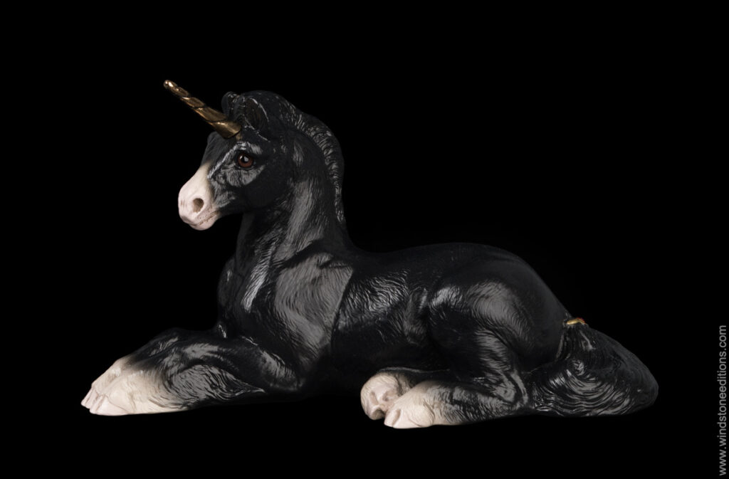 Resting Ponycorn fantasy figurine in Black with golden pewter horn, brown glass eyes, and red-colored jewels. Hand-painted collectible by Windstone Editions.