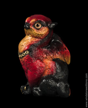 Sitting Griffin Chick figurine in fiery red and orange with gold chain and topaz colored jewel by Windstone Editions. Hand-painted fantasy collectible for indoor display.